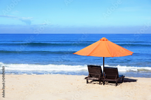 empty beach background with bright tent, chairs, surf waves and sunny sky © night_cat