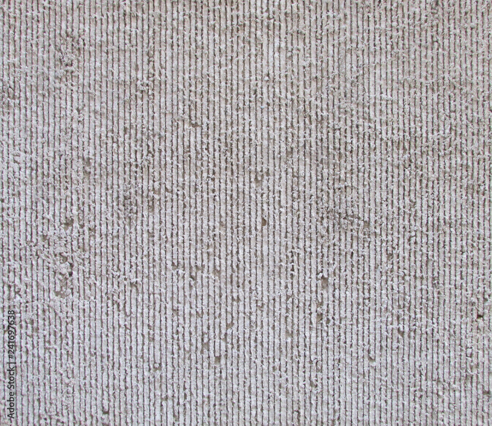Concrete wall with vertical grooves and rough surface texture Stock
