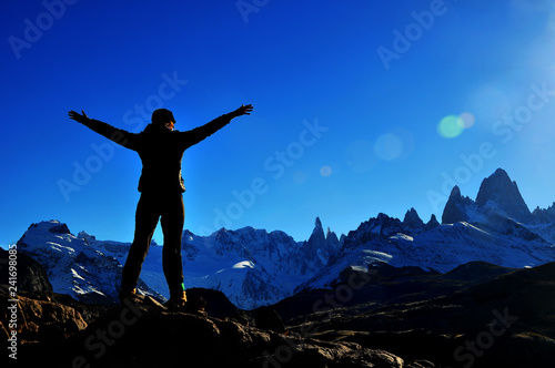 Silueta de una persona en lo alto de la montaña tras llegar a la cima