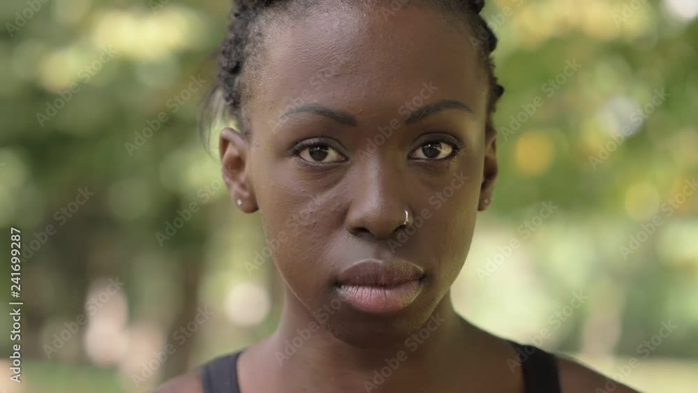 Proud attractive young black african woman wearing earphones- close up Proud attractive young black african woman wearing earphones- close up