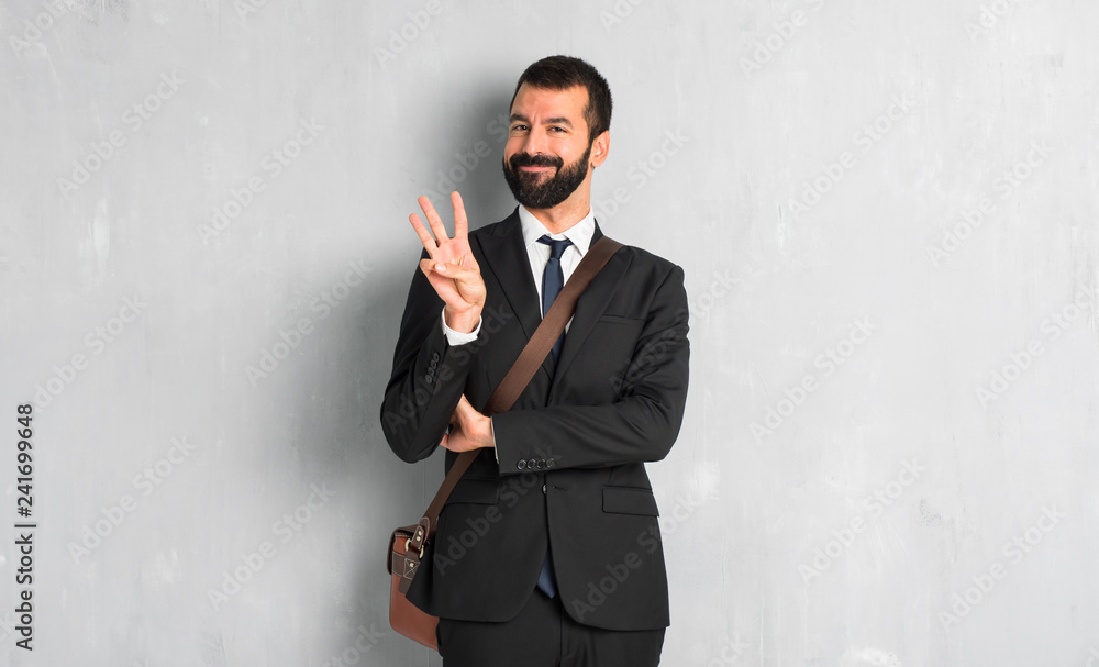 Businessman with beard happy and counting three with fingers Businessman with beard happy and counting three with fingers