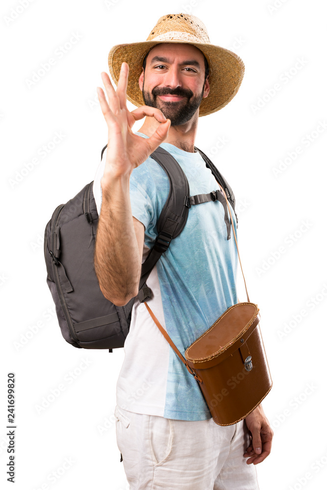Funny tourist making OK sign on isolated white background Funny tourist making OK sign on isolated white background