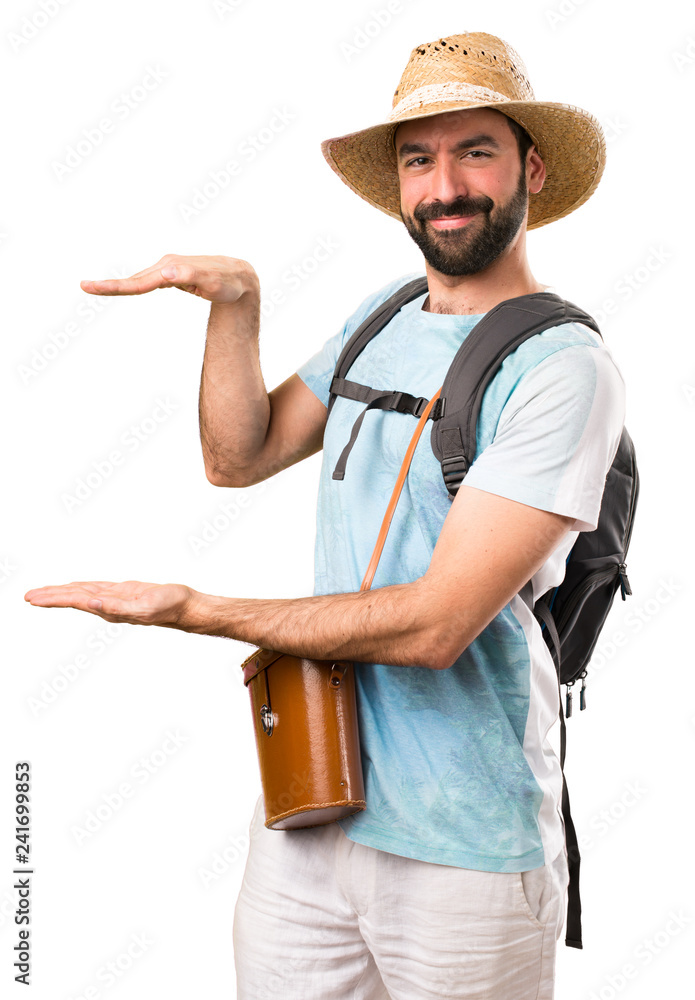 Funny tourist holding something on isolated white background Funny tourist holding something on isolated white background