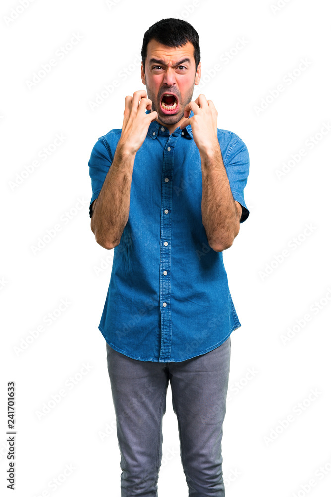 Handsome man with blue shirt annoyed and angry in furious gesture Handsome man with blue shirt annoyed and angry in furious gesture