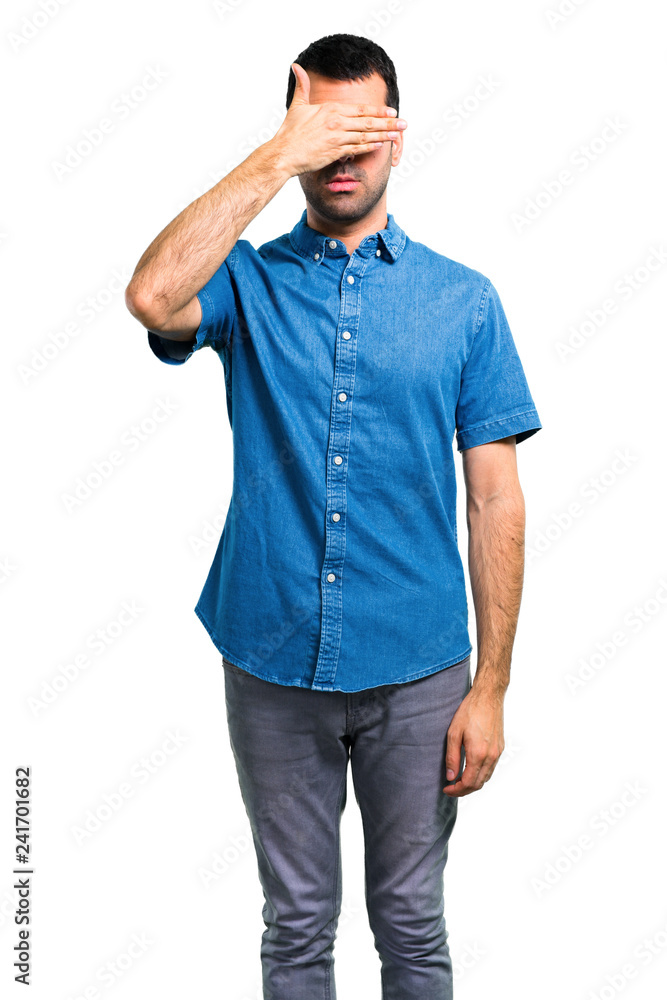 Handsome man with blue shirt covering eyes by hands Handsome man with blue shirt covering eyes by hands