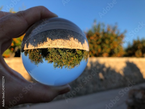 crystal ball in hand  creative photography  crystal ball refraction. 