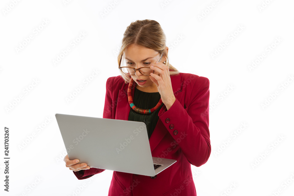 Emotional surprised businesswoman looking at the laptop screen Emotional surprised businesswoman looking at the laptop screen
