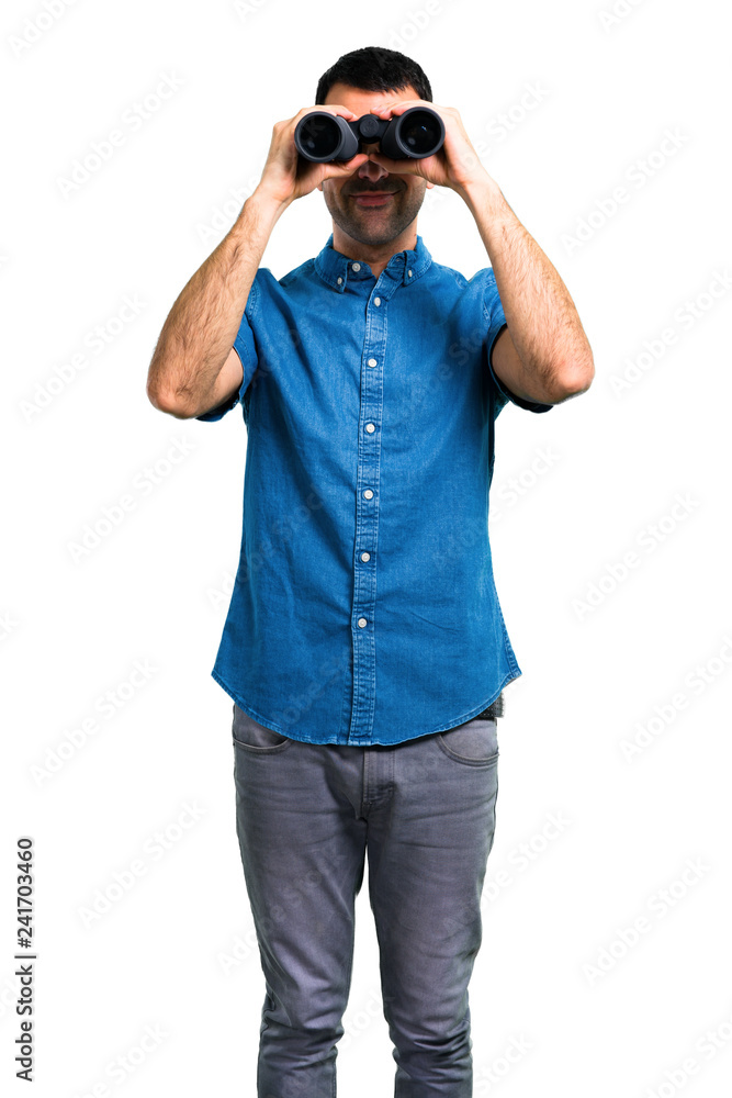 Handsome man with blue shirt with binoculars Handsome man with blue shirt with binoculars