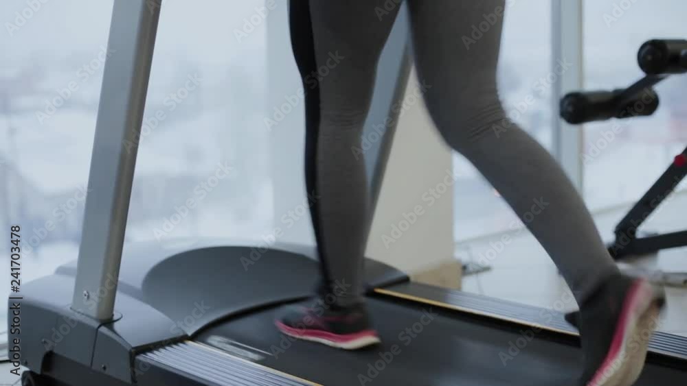 Very beautiful woman exercising on the treadmill in the gym. Very beautiful woman exercising on the treadmill in the gym.
