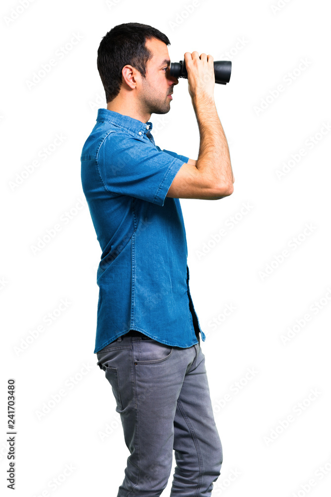 Handsome man with blue shirt with binoculars Handsome man with blue shirt with binoculars