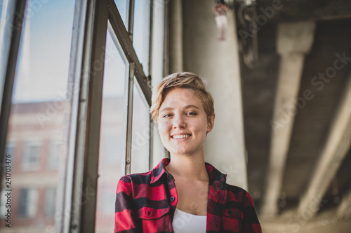 Portrait young female in loft apartment