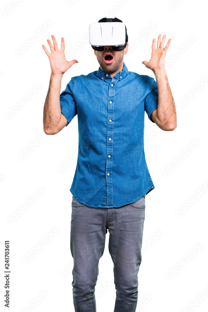 Handsome man with blue shirt using VR glasses Handsome man with blue shirt using VR glasses