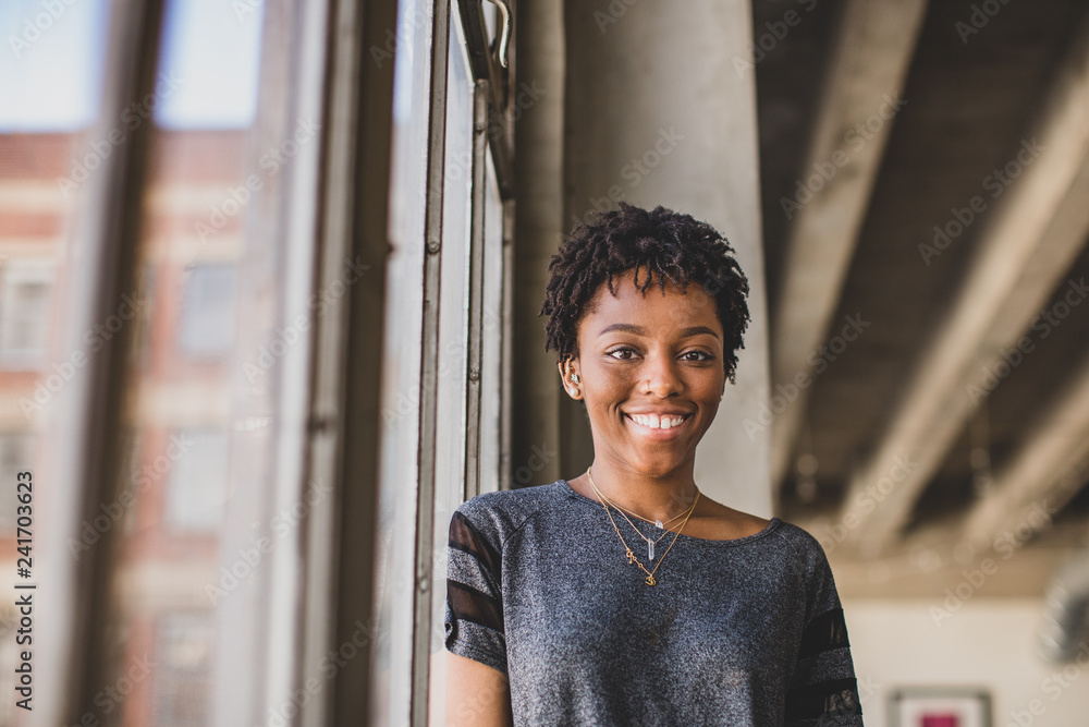 © ReeldealHD images - Portrait of young african american female looking to camera