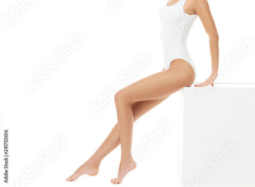 Fit and beautiful female body. Young girl in white swimsuit.