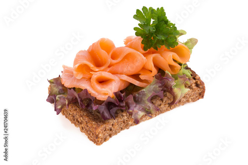 Bread with fresh salmon fillet isolated on white background, top view.