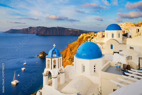 Oia town on Santorini island, Greece with traditional buildings with blue domes