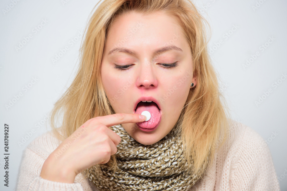 Home treatment concept. Girl take medicine to break fever. Cold flu and sore throat. Bitter pill to swallow. Headache and Take tablet relieve fever. fever remedies. Woman sick person hold tablet Home treatment concept. Girl take medicine to break fever. Cold flu and sore throat. Bitter pill to swallow. Headache and Take tablet relieve fever. fever remedies. Woman sick person hold tablet