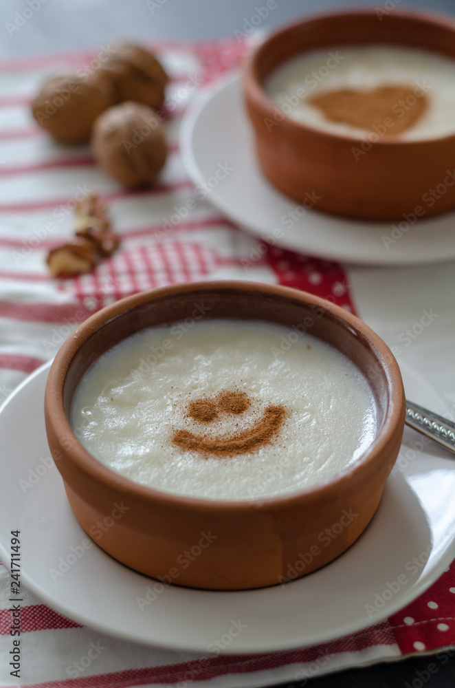 Delicious rice pudding with cinnamon in bowl, closeup Delicious rice pudding with cinnamon in bowl, closeup