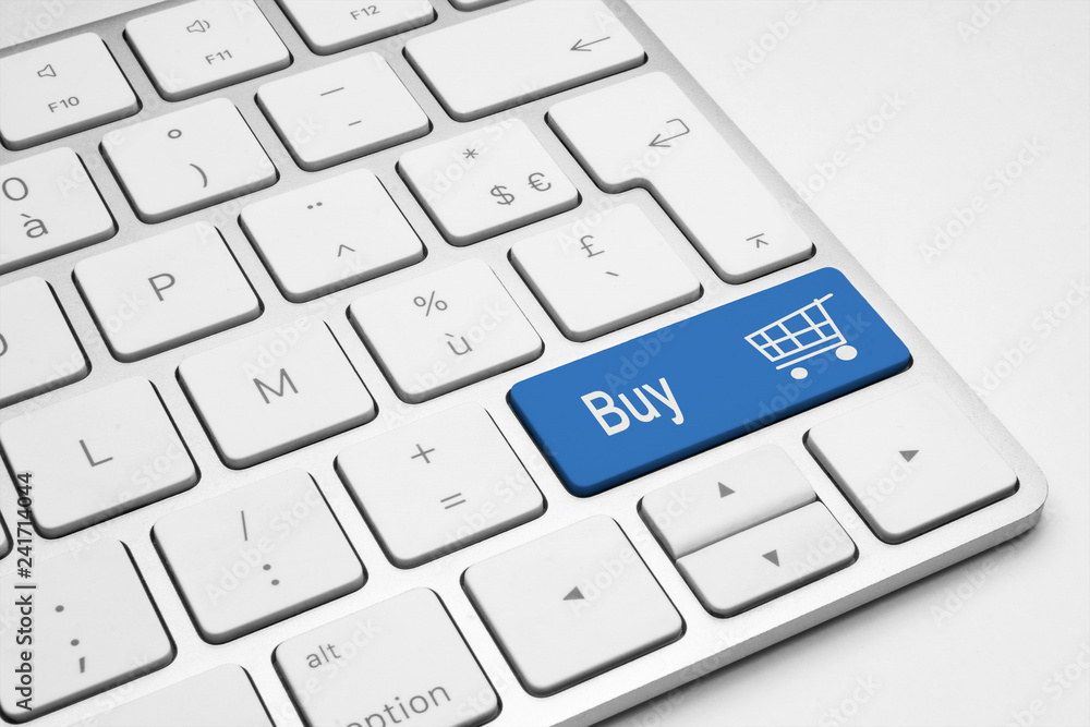 Buy push blue button with a cart icon on a white isolated keyboard. Online shopping concept. Buy push blue button with a cart icon on a white isolated keyboard. Online shopping concept.