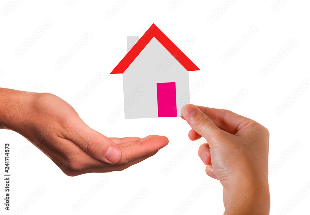 real estate and housing damage cover advertising with woman hand holding house paper cut shape depositing it into protective insurance company hand isolated on white real estate and housing damage cover advertising with woman hand holding house paper cut shape depositing it into protective insurance company hand isolated on white