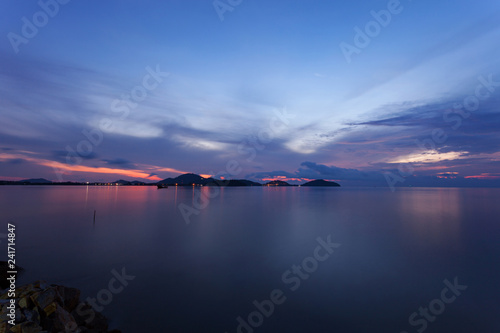 Long exposure image of dramatic sunset or sunrise sky clouds over tropical sea.