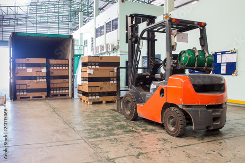 The forklift loading pallet with a forklift into a truck.