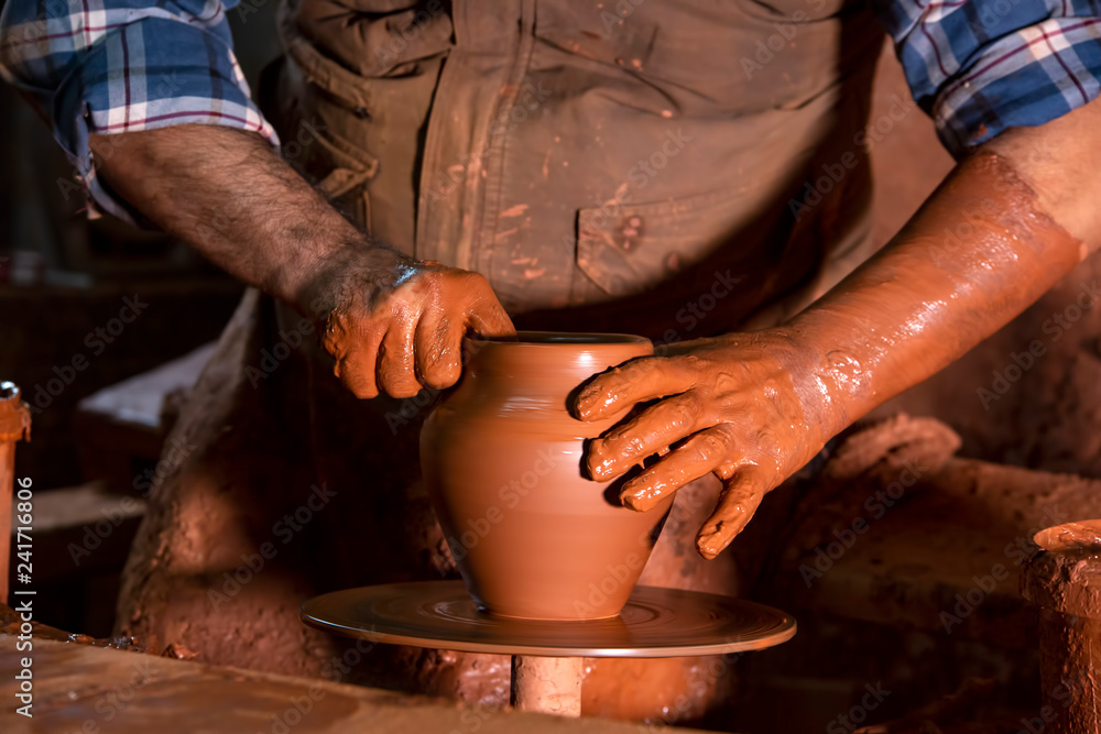 Professional potter making bowl in pottery workshop, studio. Professional potter making bowl in pottery workshop, studio.