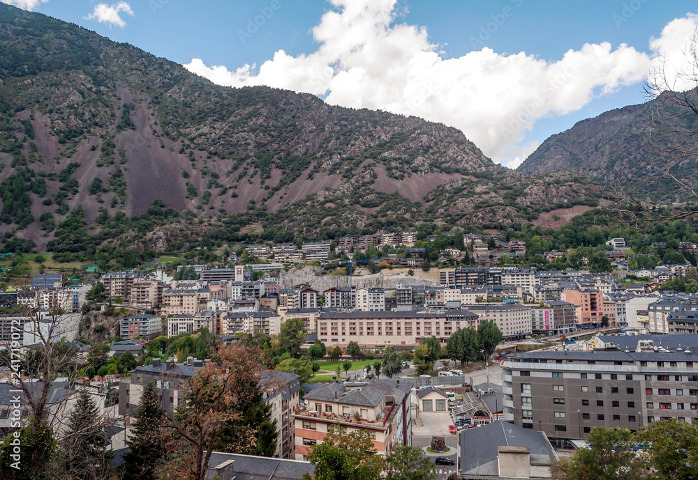 Obraz premium ANDORRA LA VELLA, ANDORRA - SEPTEMBER 2014. Anonymous people walking through the central streets of Andorra on a sunny day. It is a city surrounded by the mountains of the Pyrenees.