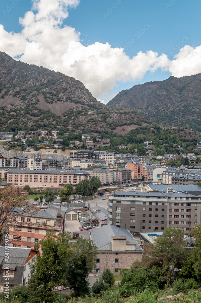 ANDORRA LA VELLA, ANDORRA - SEPTEMBER 2014. Anonymous people walking through the central streets of Andorra on a sunny day. It is a city surrounded by the mountains of the Pyrenees.