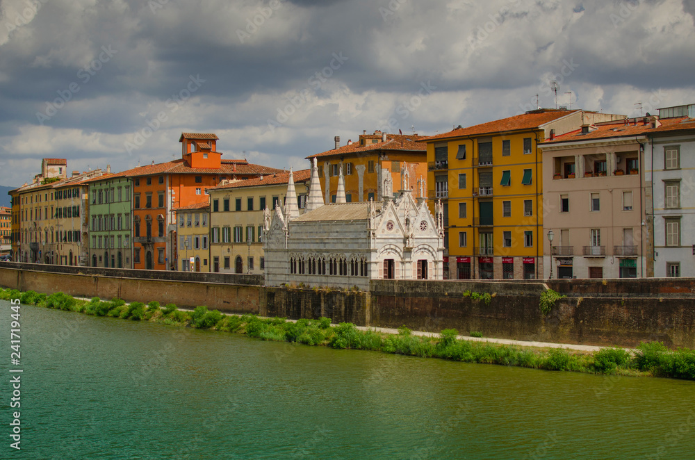 View on  Arno River in Pisa with gothic cathedral Santa Maria della Spina, Italy