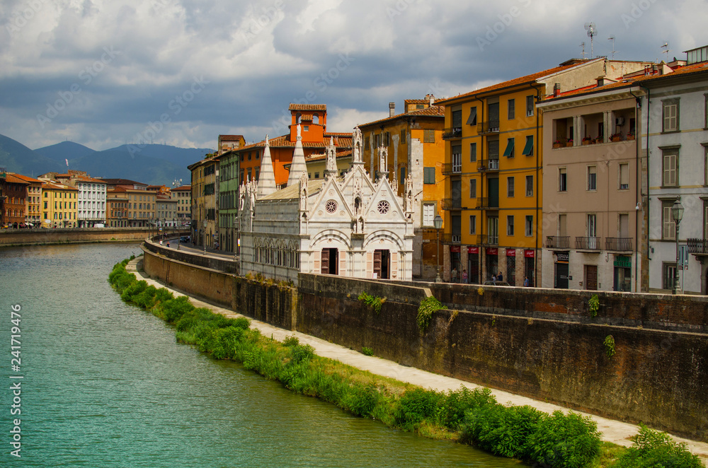 View on  Arno River in Pisa with gothic cathedral Santa Maria della Spina