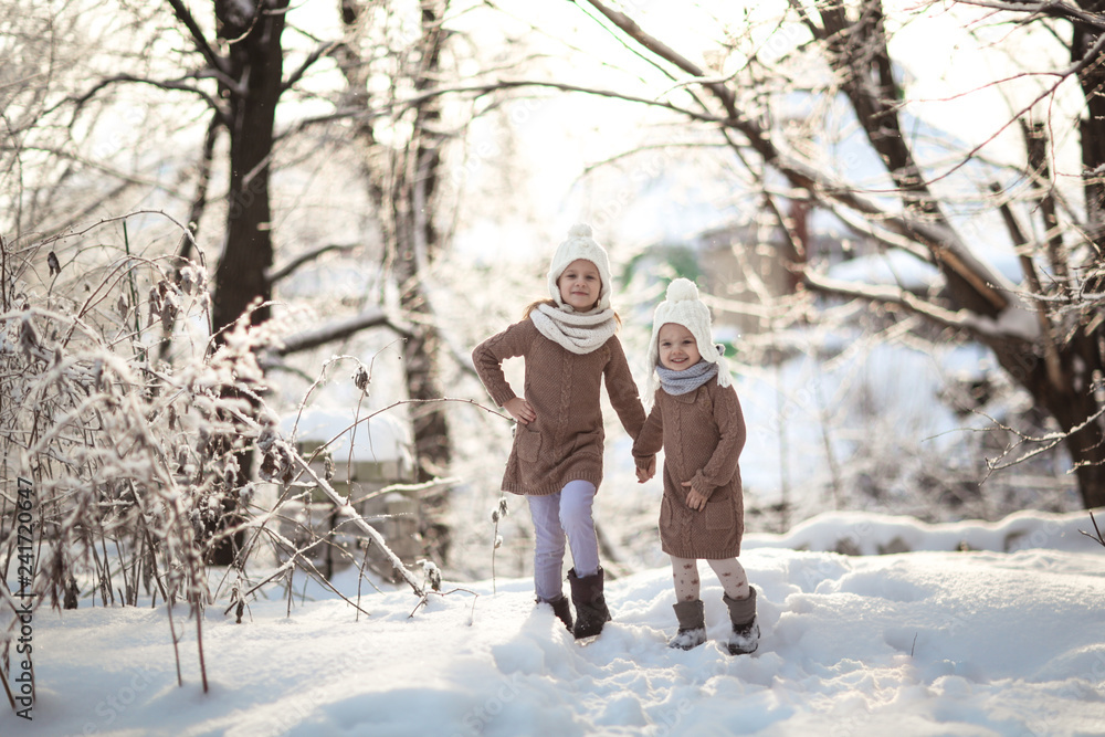 Children friends play among snowdrifts together.