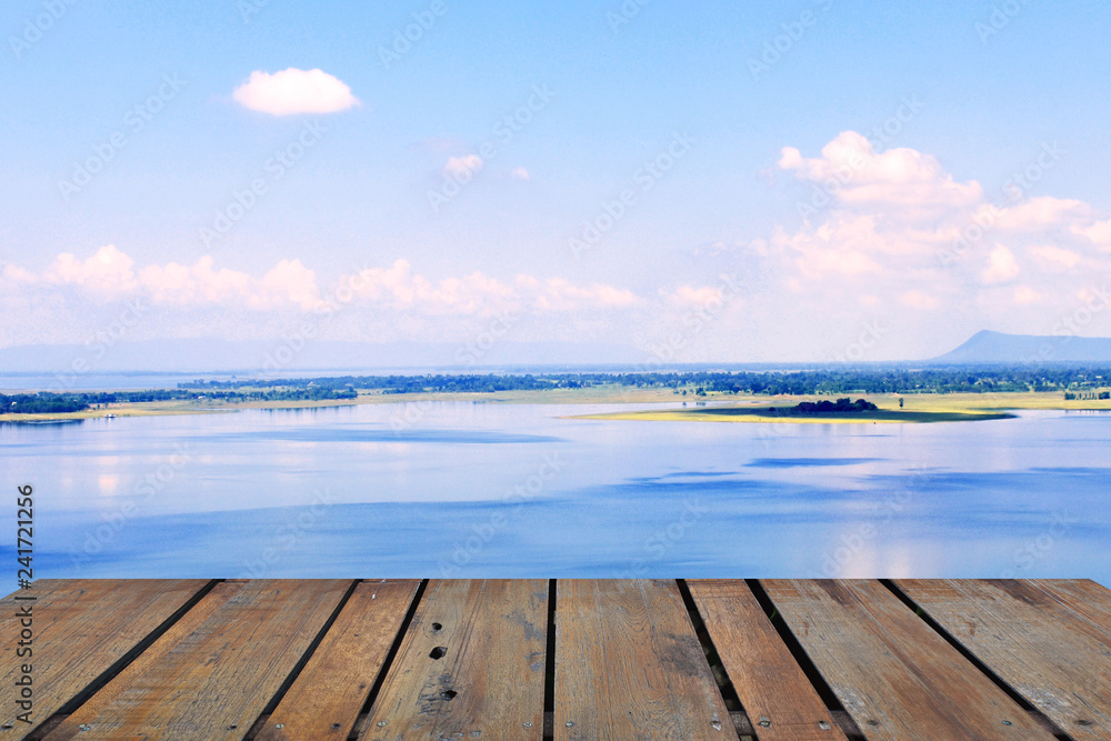 Old wood terrace with perspective view on blue lake and blue sky. Apply for poster, background, backdrop. There is copy free space fot texture.