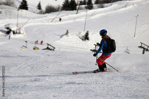 Female skier riding the slope