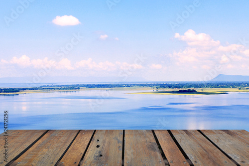 Old wood terrace with perspective view on blue lake and blue sky. Apply for poster  background  backdrop. There is copy free space fot texture.