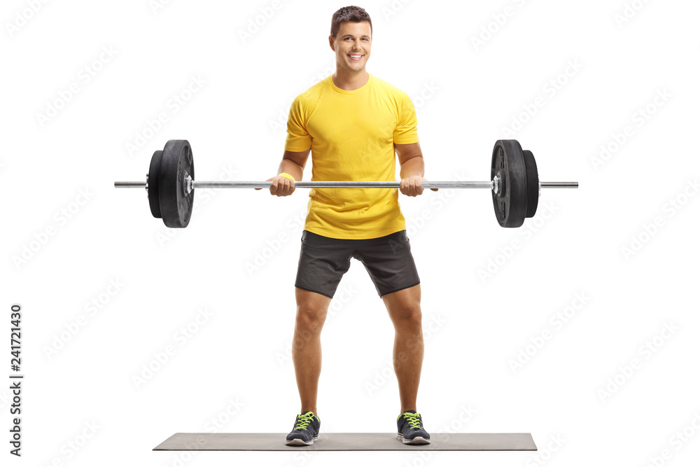 Fototapeta premium Young man in a yellow t-shirt exercising weightlifting