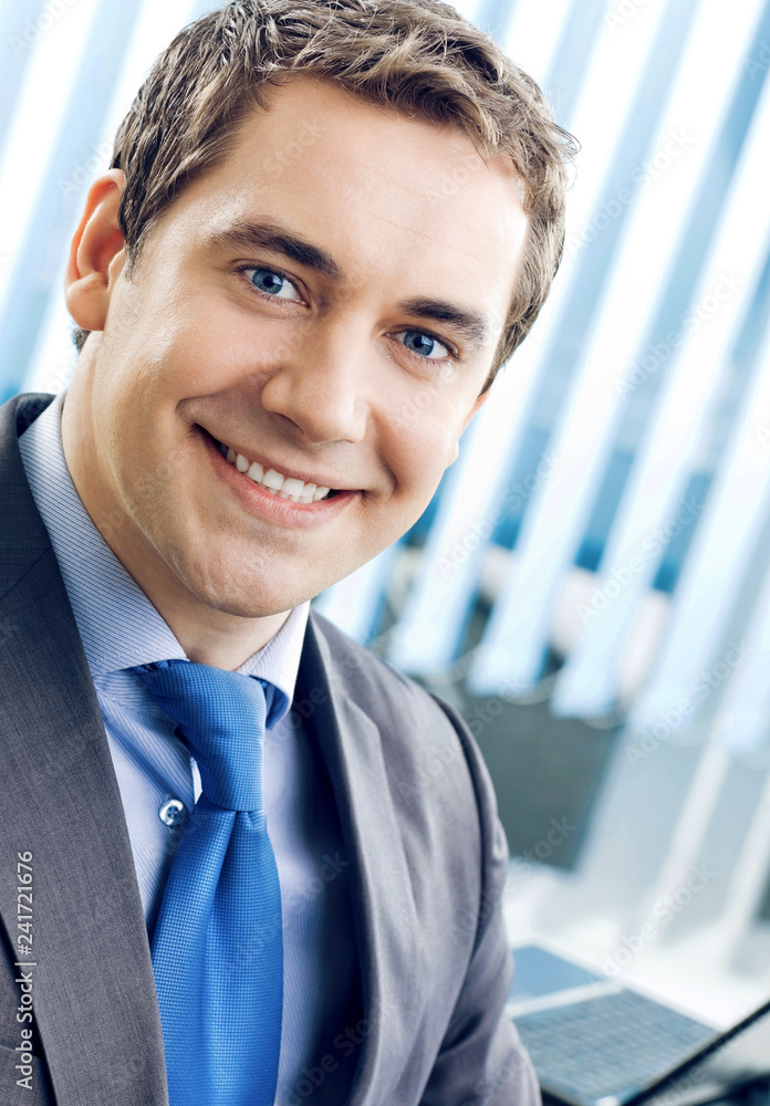 Portrait of smiling businessman at office Portrait of smiling businessman at office