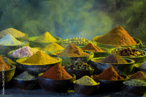 Smoke  Aromatic spices on wooden background