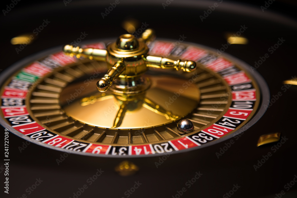 Gaming table, roulette wheel in motion Gaming table, roulette wheel in motion