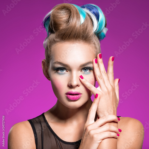 Beautiful woman with fashion hairstyle and pink nails.