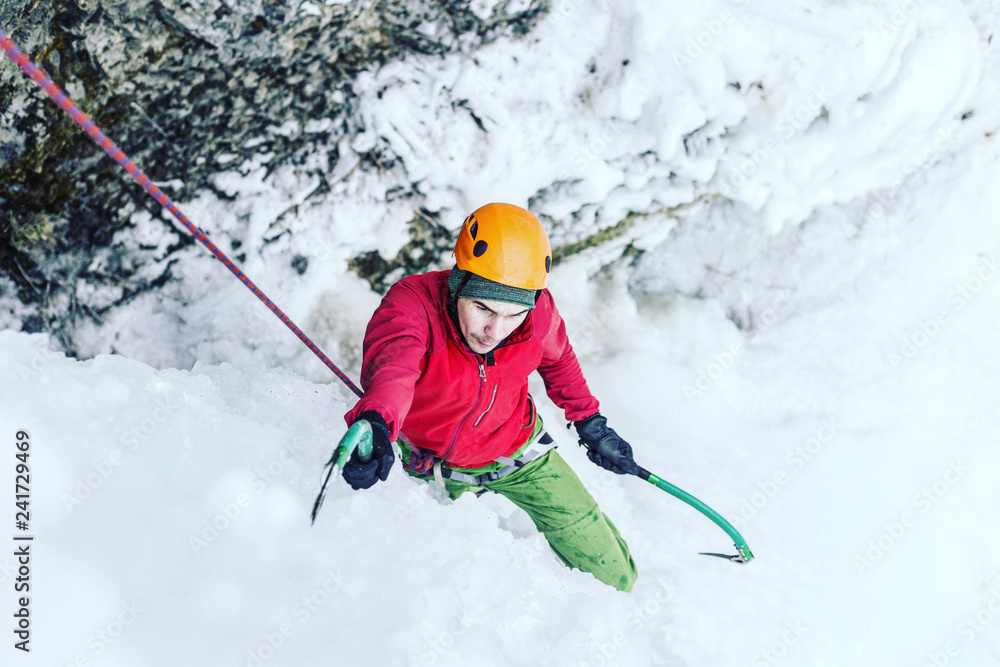 Ice climbing on a frozen waterfall. Ice climbing on a frozen waterfall.