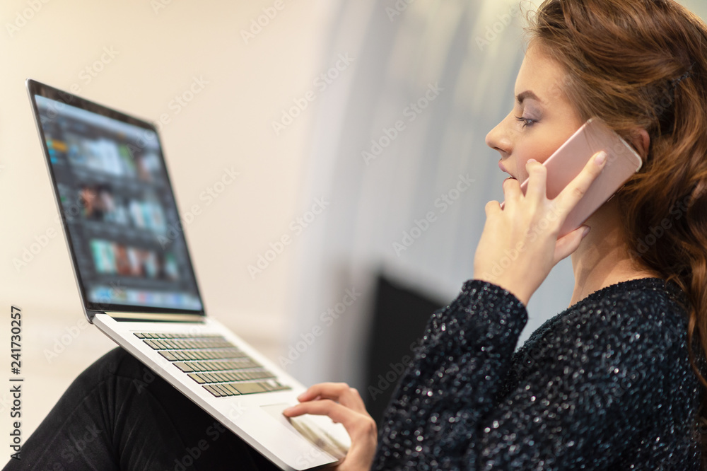 Attractive woman calling by smart phone working on computer. Attractive woman calling by smart phone working on computer.
