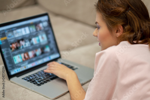 Attractive woman with laptop at home.