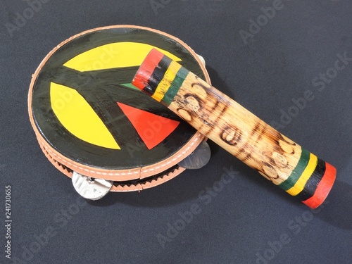 Close-up of two colorful handmade Brazilian percussion instruments: pandeiro (tambourine) and 