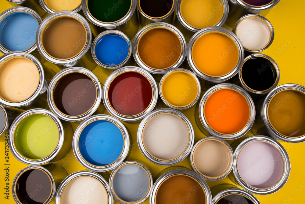 Open buckets with a paint, yellow background Open buckets with a paint, yellow background