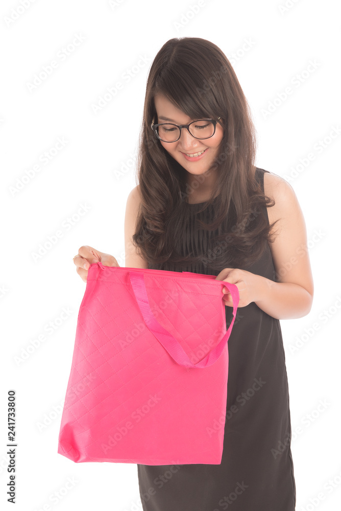 Happy asian woman wearing glasses looking at pink bag on white background. Happy asian woman wearing glasses looking at pink bag on white background.