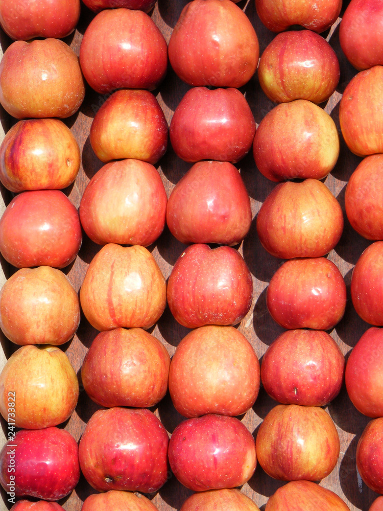 red apples in a crate as background