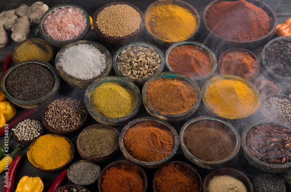 Variety of spices and herbs on kitchen table Variety of spices and herbs on kitchen table