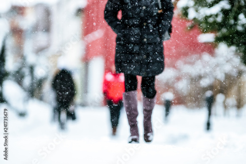 Foto Pedestrians walking on snowy sidewalk