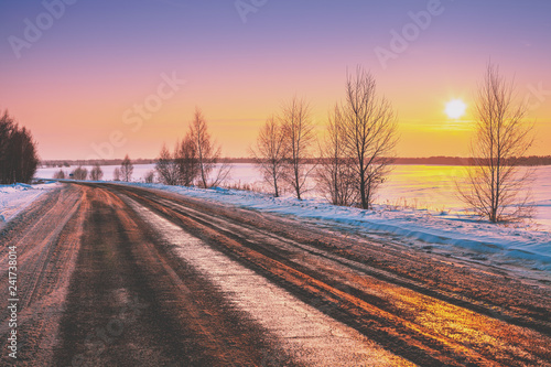 Winter road at sunrise. Winter rural landscape